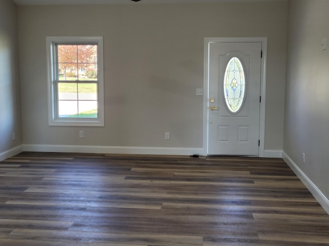 entryway with dark wood-type flooring and baseboards