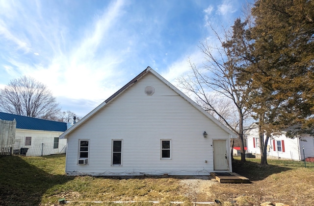 back of property with fence and a lawn