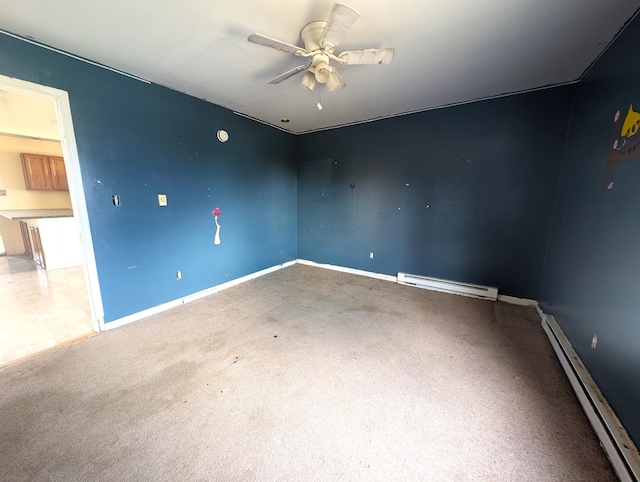 carpeted spare room with a baseboard radiator, ceiling fan, and baseboards