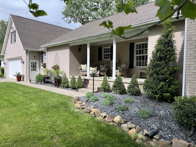 ranch-style home featuring brick siding, a shingled roof, a garage, and a front yard