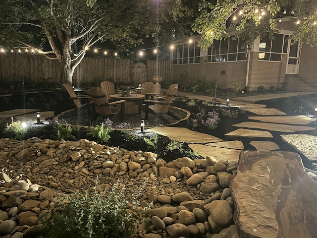 view of yard with fence, an outdoor fire pit, and a patio area