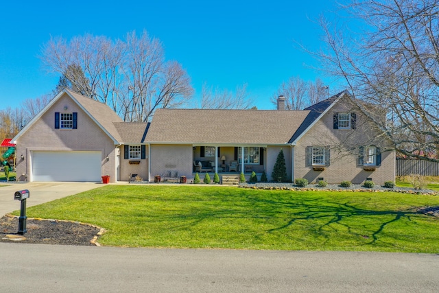 view of front of property featuring covered porch, a chimney, a front lawn, concrete driveway, and brick siding