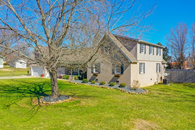 view of home's exterior with brick siding, cooling unit, driveway, and board and batten siding