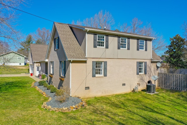 view of home's exterior featuring brick siding, a shingled roof, and cooling unit
