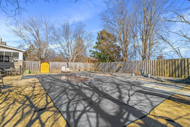 view of swimming pool with a fenced backyard and a gate