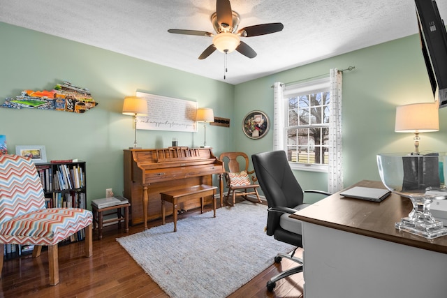 home office featuring ceiling fan, wood finished floors, and a textured ceiling