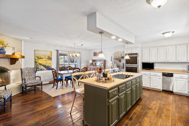 kitchen with white cabinets, double oven, dark wood-type flooring, a center island, and light countertops