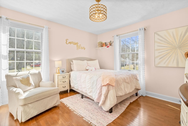 bedroom featuring hardwood / wood-style floors and baseboards