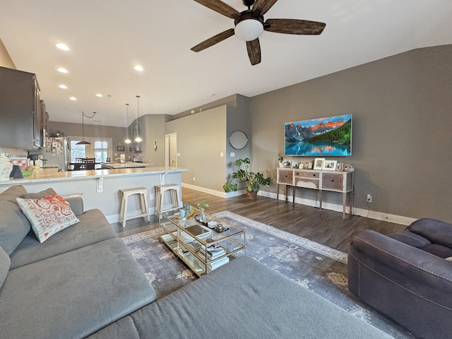 living area featuring ceiling fan, baseboards, dark wood-type flooring, and recessed lighting