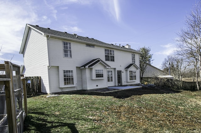 view of front facade featuring a patio, a front lawn, a chimney, and fence