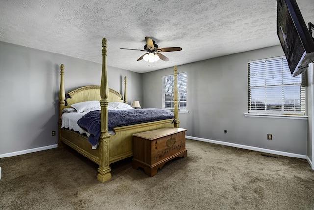 carpeted bedroom with ceiling fan, baseboards, and a textured ceiling