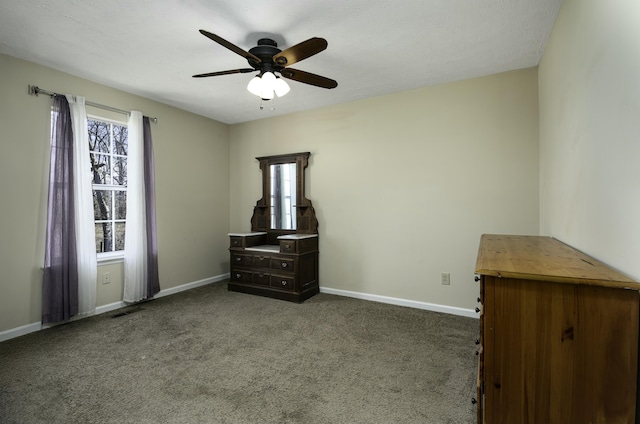 unfurnished bedroom with carpet, visible vents, ceiling fan, and baseboards