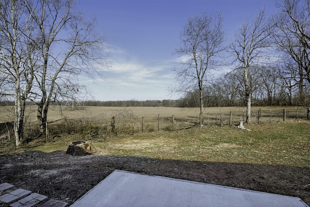 view of yard featuring fence and a rural view