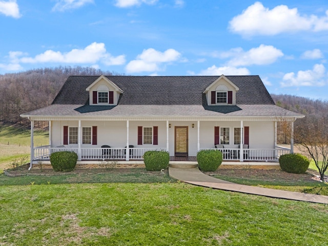 farmhouse-style home featuring a porch, roof with shingles, and a front yard