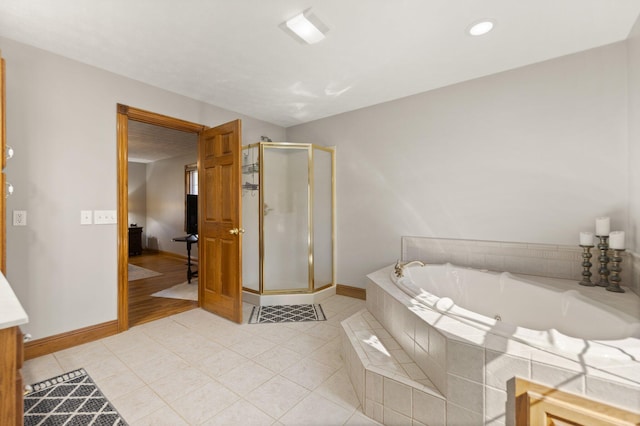 full bath featuring a garden tub, tile patterned flooring, a shower stall, and baseboards