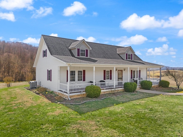 view of front facade with central AC, a porch, a front lawn, and roof with shingles