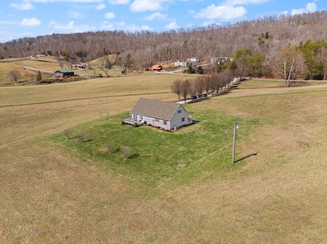 birds eye view of property with a view of trees and a rural view