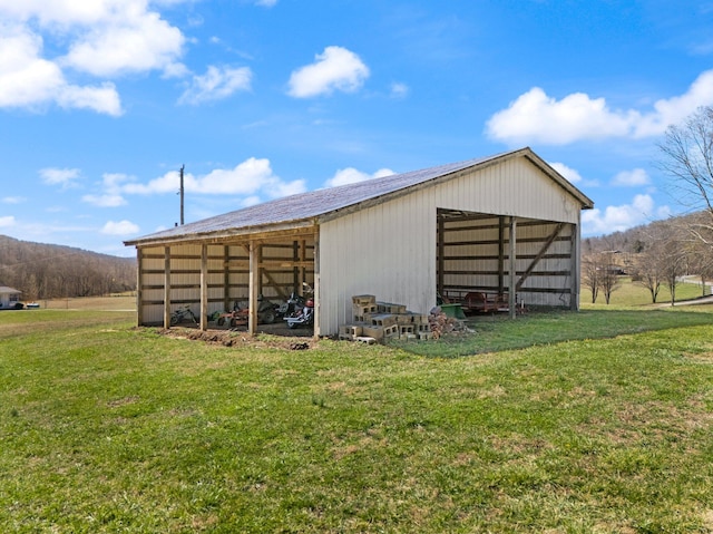 view of pole building with a yard