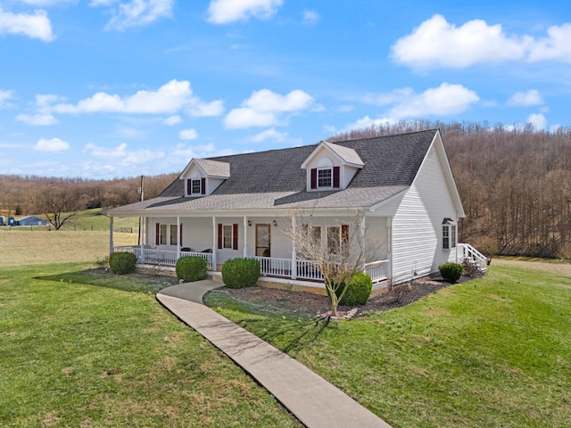 view of front of house with covered porch, roof with shingles, and a front yard