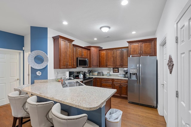 109 Acorn Path, Georgetown, KY 40324 - kitchen featuring stainless steel appliances, a peninsula, light countertops, a kitchen bar, and recessed lighting