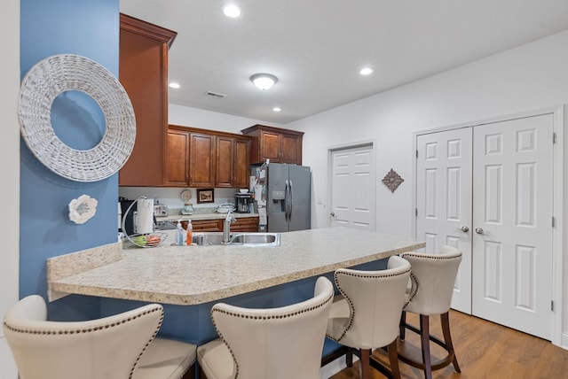 109 Acorn Path, Georgetown, KY 40324 - kitchen featuring stainless steel fridge, light countertops, a kitchen breakfast bar, light wood-style flooring, and a peninsula
