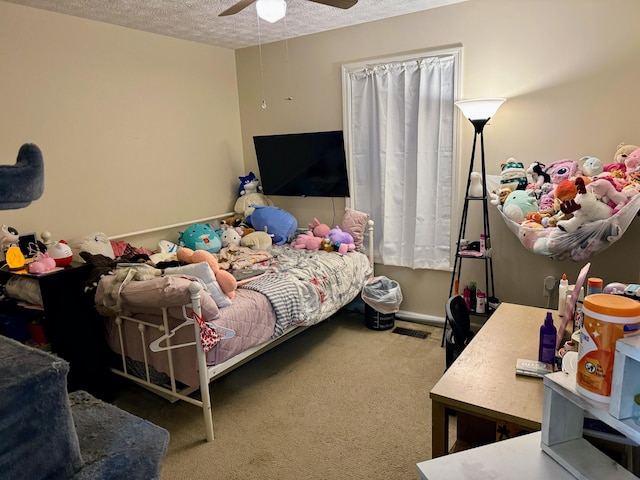 carpeted bedroom with visible vents, ceiling fan, and a textured ceiling