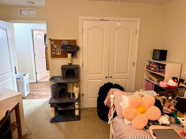 bedroom featuring carpet floors, a closet, and visible vents