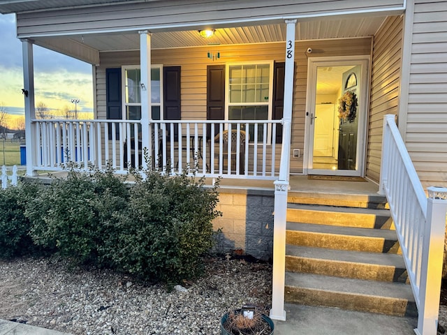 view of exterior entry with a porch