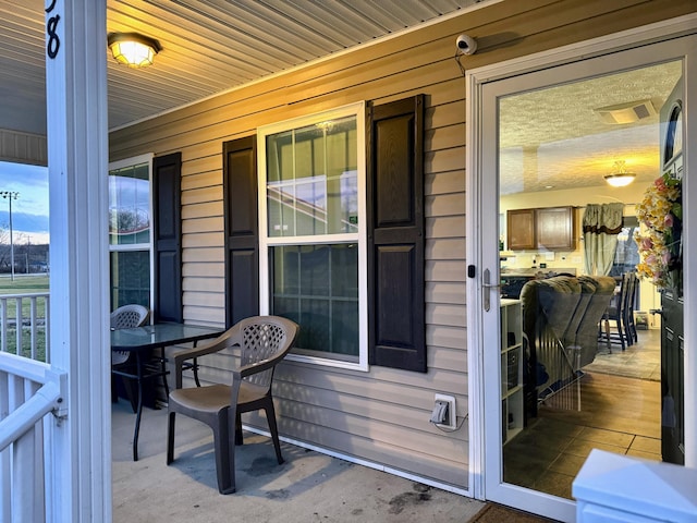 exterior space with covered porch and visible vents