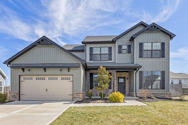 view of front of house featuring a garage, a front yard, stone siding, and driveway