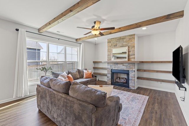 living room featuring visible vents, baseboards, dark wood-style flooring, a fireplace, and beam ceiling