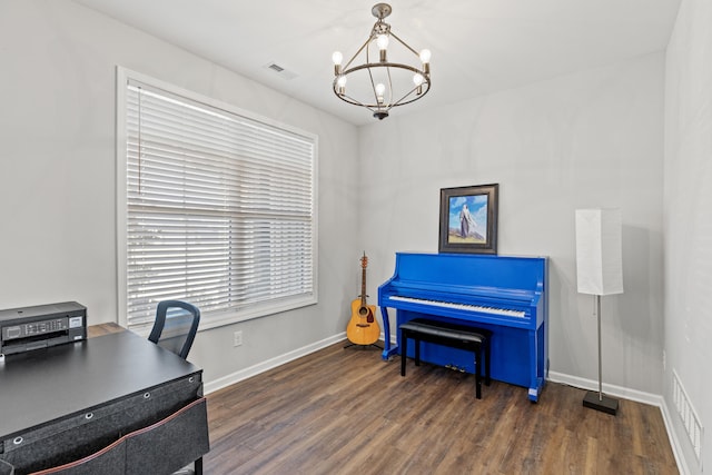 home office with baseboards, visible vents, a chandelier, and wood finished floors