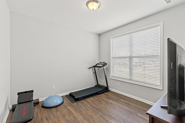 workout room with visible vents, baseboards, and wood finished floors