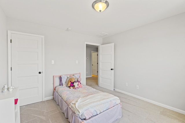 bedroom featuring baseboards and light colored carpet