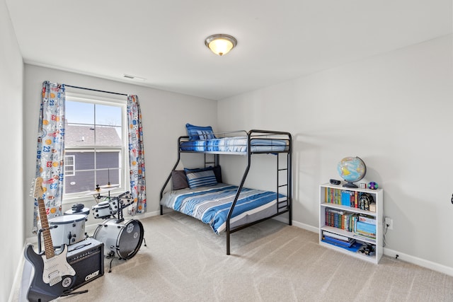 carpeted bedroom featuring visible vents and baseboards