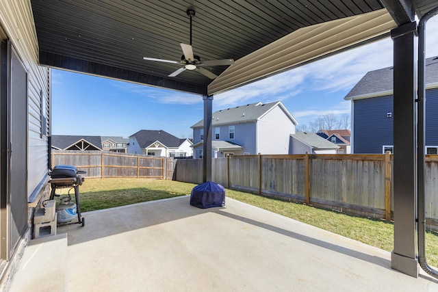 view of patio / terrace featuring a fenced backyard, a residential view, and a ceiling fan