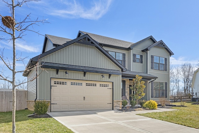 craftsman-style home with a garage, fence, stone siding, concrete driveway, and a front yard