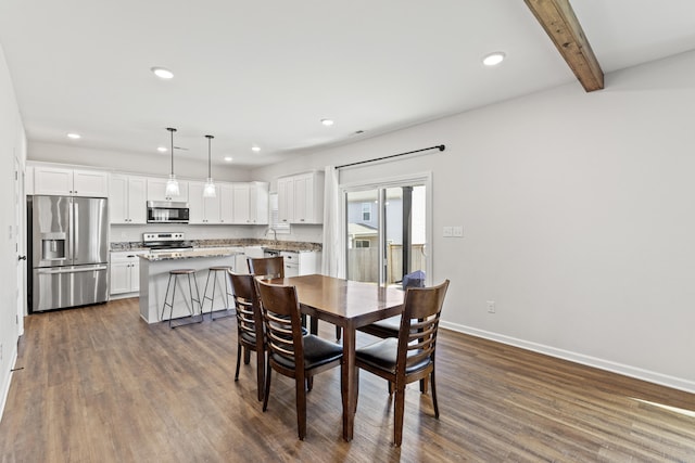 dining space with dark wood-type flooring, recessed lighting, beam ceiling, and baseboards