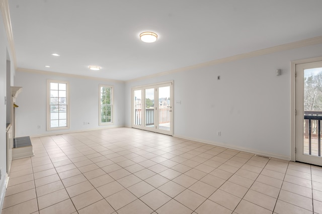 spare room featuring light tile patterned floors, a wealth of natural light, and crown molding