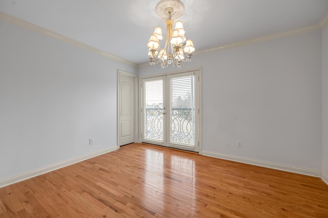 unfurnished room with ornamental molding, light wood-style flooring, and baseboards