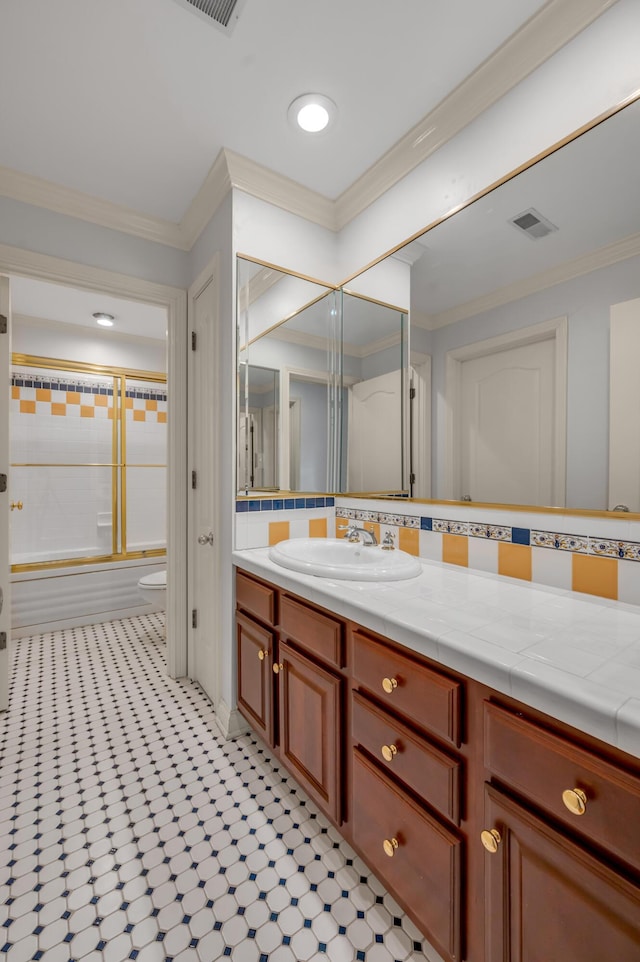 full bath with toilet, ornamental molding, vanity, and visible vents