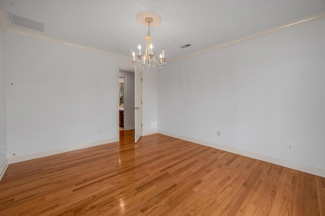 empty room featuring visible vents, baseboards, light wood-style flooring, crown molding, and a notable chandelier