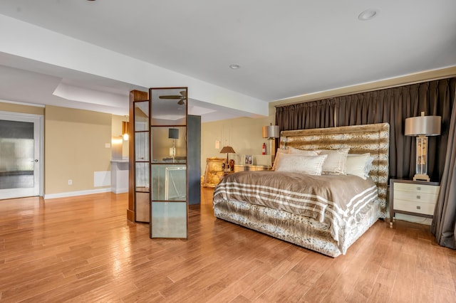 bedroom featuring baseboards, wood finished floors, and recessed lighting