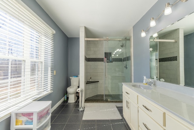 full bathroom featuring a shower stall, vanity, toilet, and tile patterned floors