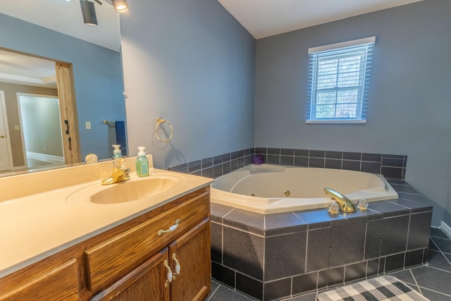 bathroom featuring a whirlpool tub and vanity