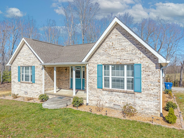 ranch-style home with brick siding, crawl space, a shingled roof, and a front lawn