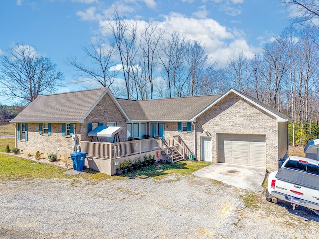 single story home featuring a garage, concrete driveway, brick siding, and roof with shingles