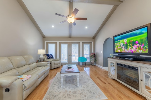 living room with baseboards, lofted ceiling with beams, ceiling fan, french doors, and light wood-style floors