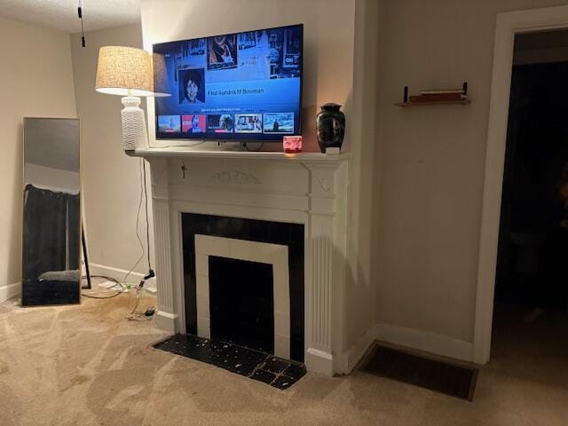 carpeted living room with baseboards and a tiled fireplace