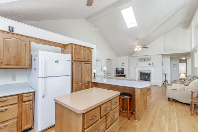 kitchen with ceiling fan, light wood finished floors, open floor plan, and freestanding refrigerator